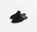 Pair of black loafers on a white background