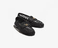 Black woven shoes on a white background