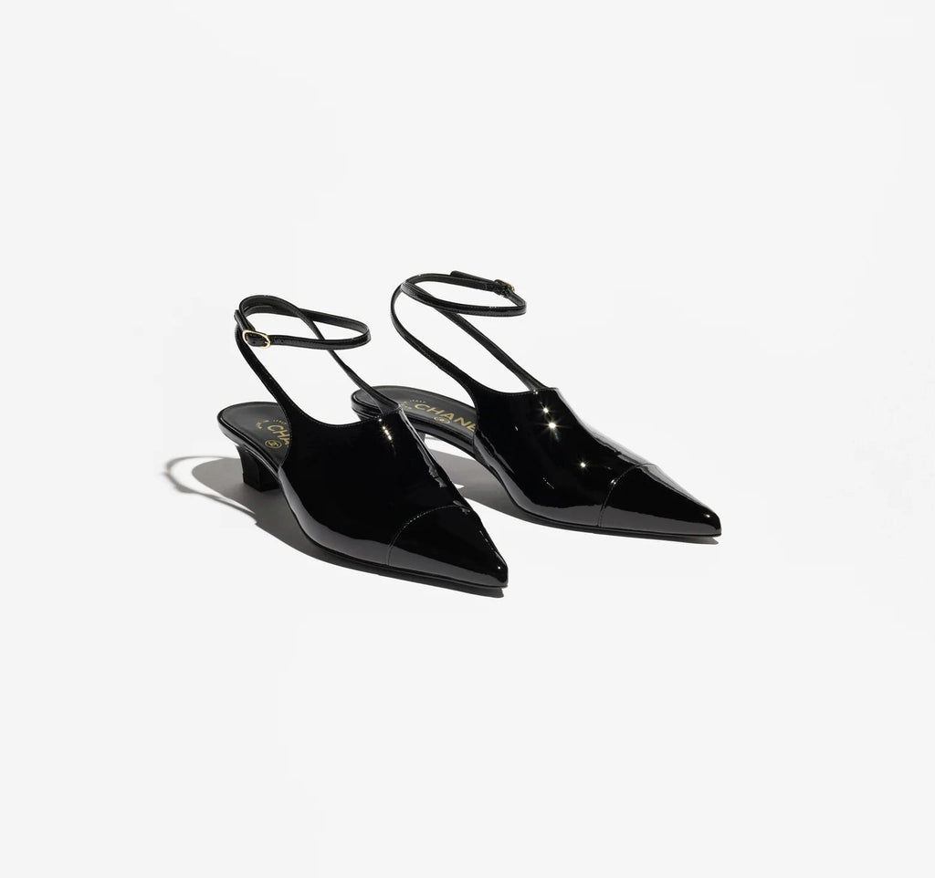 Black pointed-toe shoes on a white background