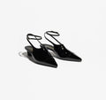 Black pointed-toe shoes on a white background