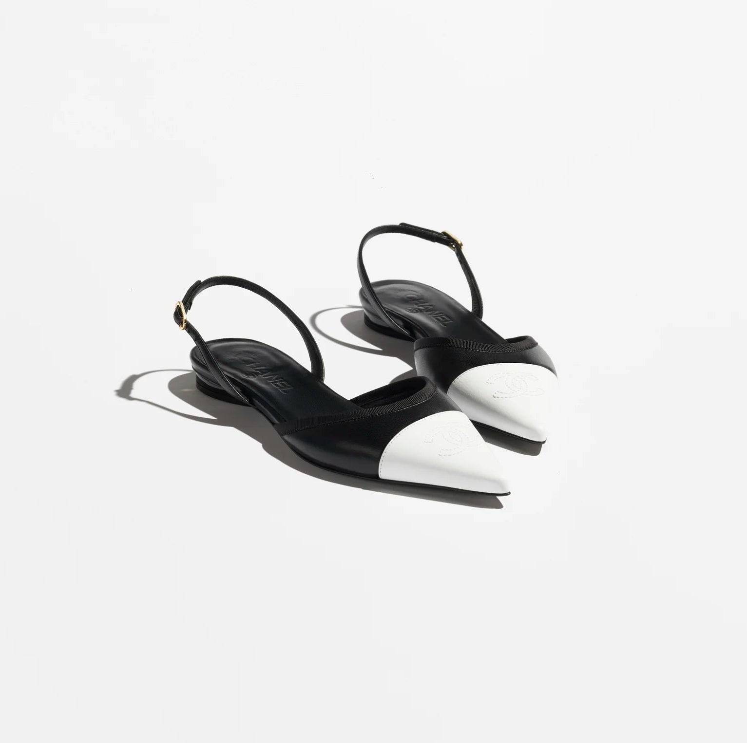 Black high-heeled sandals on a white background