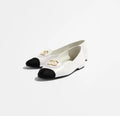 White shoe with black sole on a white background